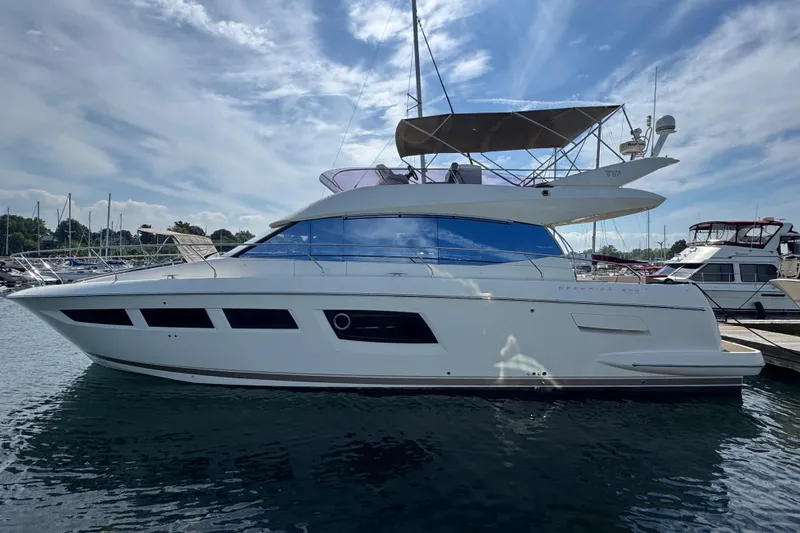  Yacht Photos Pics 2013 Prestige 500 yacht docked under a partly cloudy sky.