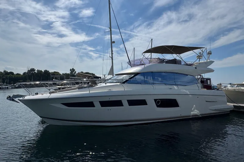  Yacht Photos Pics Luxury 2013 Prestige 500 yacht docked in a serene marina setting.