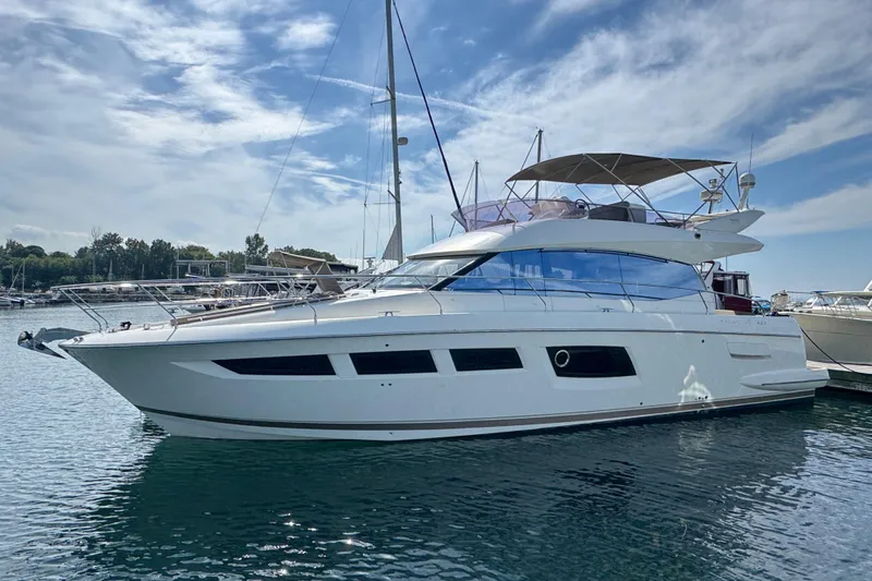  Yacht Photos Pics 2013 Prestige 500 yacht docked in a marina under a partly cloudy sky.