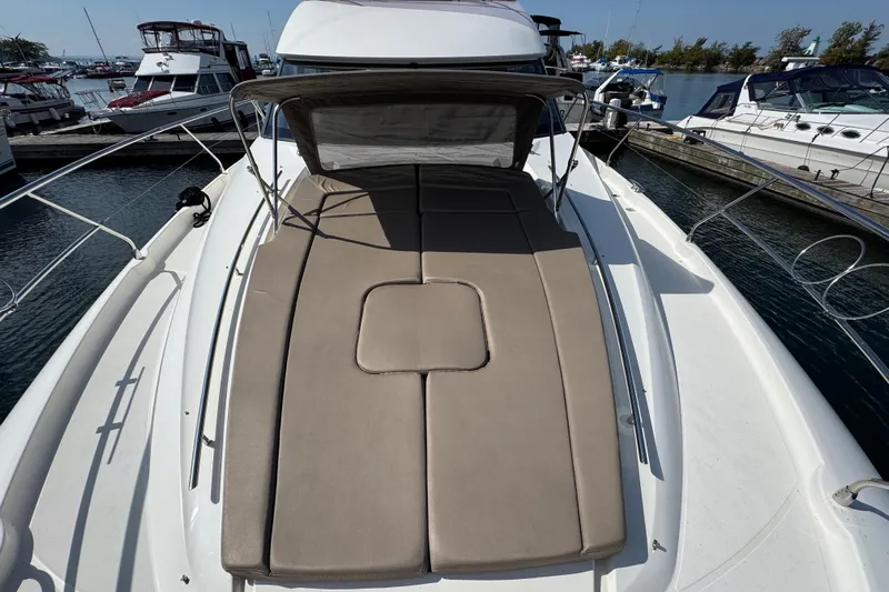  Yacht Photos Pics 2013 Prestige 500 yacht with sunpad, docked at marina, surrounded by other boats.