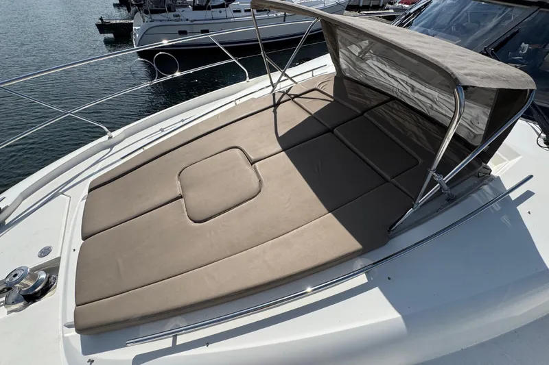  Yacht Photos Pics Luxury sunbathing area on 2013 Prestige 500 yacht, featuring cushioned seating and canopy.