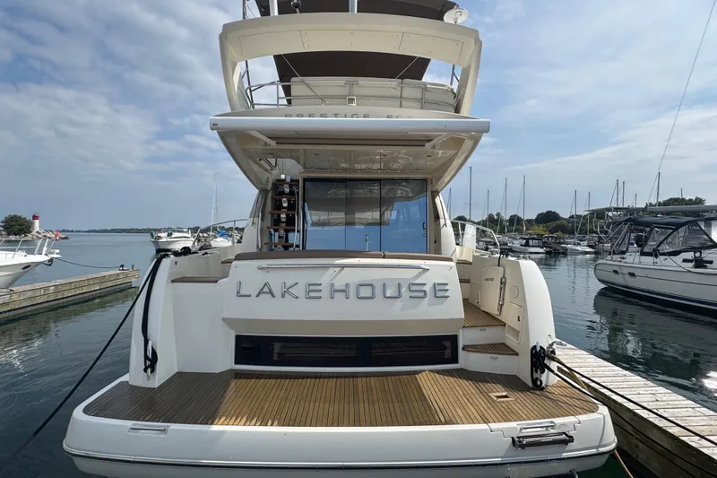  Yacht Photos Pics Rear view of 2013 Prestige 500 yacht named "Lakehouse" docked at a marina.