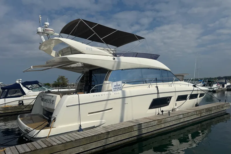  Yacht Photos Pics Luxury 2013 Prestige 500 yacht docked at marina under cloudy sky.