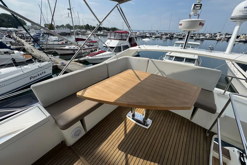  Yacht Photos Pics Luxurious 2013 Prestige 500 yacht with elegant outdoor seating and wooden table at marina.