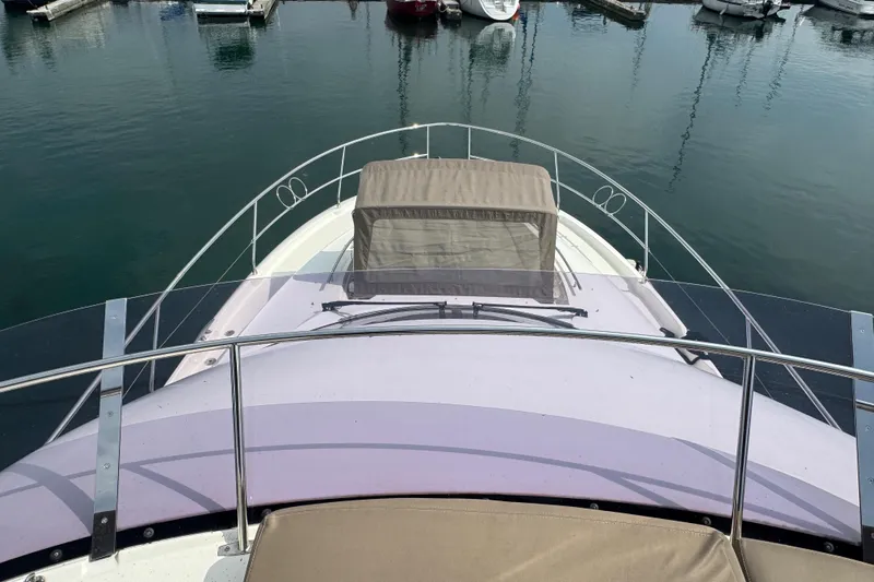  Yacht Photos Pics Prestige 500 yacht bow view, 2013 model, docked in marina with calm waters.
