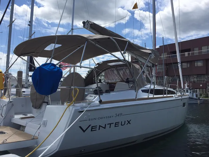 Venteux Yacht Photos Pics 2016 Jeanneau Sun Odyssey 349 sailboat docked at marina under cloudy sky.