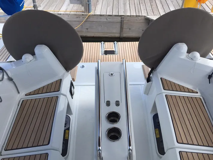 Venteux Yacht Photos Pics Cockpit of 2016 Jeanneau Sun Odyssey 349 sailboat with dual steering wheels and teak flooring.