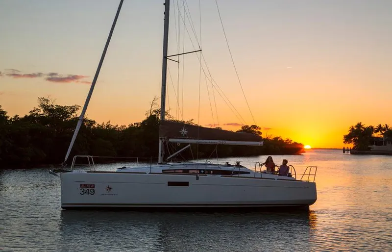 Venteux Yacht Photos Pics 2016 Jeanneau Sun Odyssey 349 sailboat at sunset on tranquil water.
