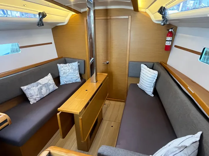 Venteux Yacht Photos Pics Interior of 2016 Jeanneau Sun Odyssey 349 sailboat with cozy seating and nautical decor.