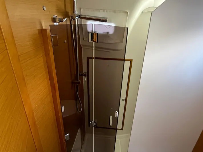 Venteux Yacht Photos Pics Shower area in 2016 Jeanneau Sun Odyssey 349 yacht, featuring modern glass door and wood accents.