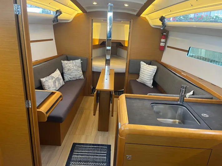 Venteux Yacht Photos Pics Interior of 2016 Jeanneau Sun Odyssey 349 sailboat with cozy seating and modern kitchen.