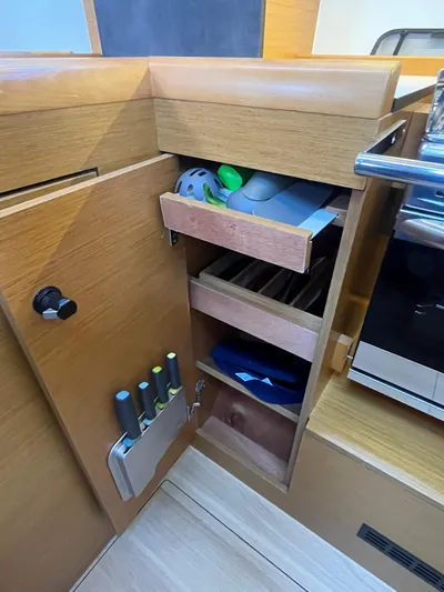 Venteux Yacht Photos Pics Compact kitchen storage in 2016 Jeanneau Sun Odyssey 349 sailboat, featuring organized shelves and knife holder.