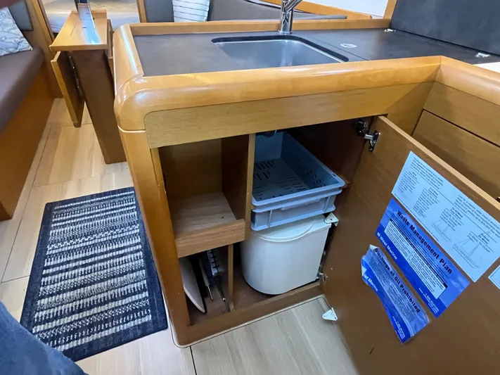 Venteux Yacht Photos Pics Interior of 2016 Jeanneau Sun Odyssey 349 yacht kitchen with open cabinet and sink.