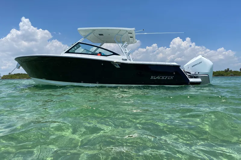  Yacht Photos Pics 2022 Blackfin 272DC boat on clear water under blue sky.
