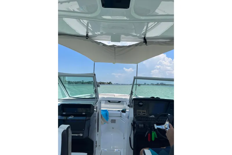  Yacht Photos Pics Interior view of 2022 Blackfin 272DC boat, showcasing helm and open water ahead.