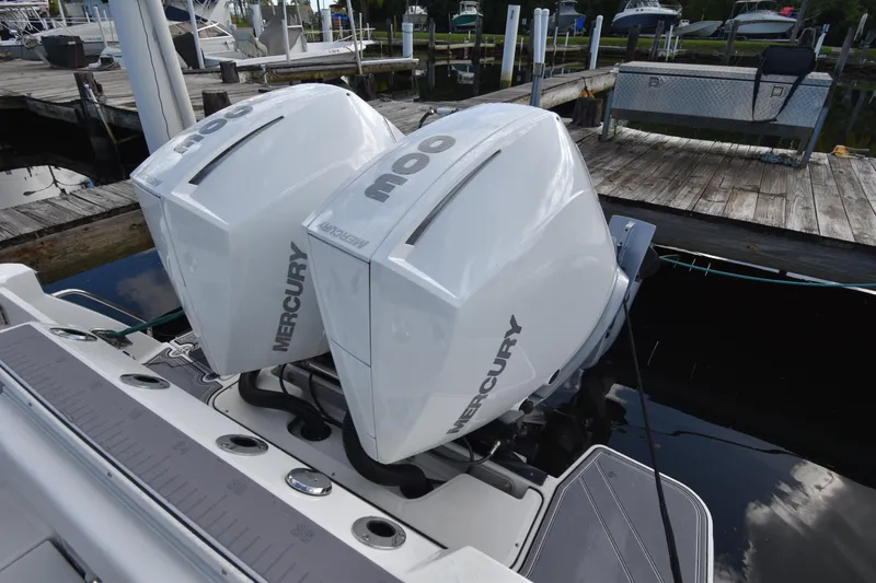  Yacht Photos Pics Twin Mercury outboard engines on a 2022 Blackfin 272DC boat at a dock.