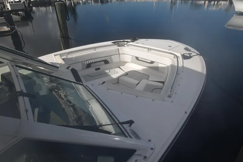  Yacht Photos Pics 2022 Blackfin 272DC boat docked, featuring spacious seating and sleek design.