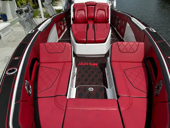  Yacht Photos Pics Luxurious red interior of 2022 Deep Impact 399 boat with diamond-patterned seating.