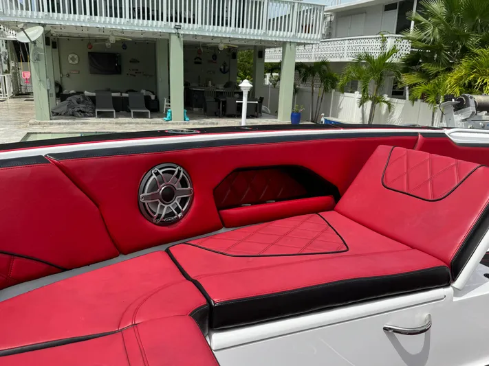  Yacht Photos Pics Luxurious red and black seating on 2022 Deep Impact 399 boat, featuring stylish speaker.