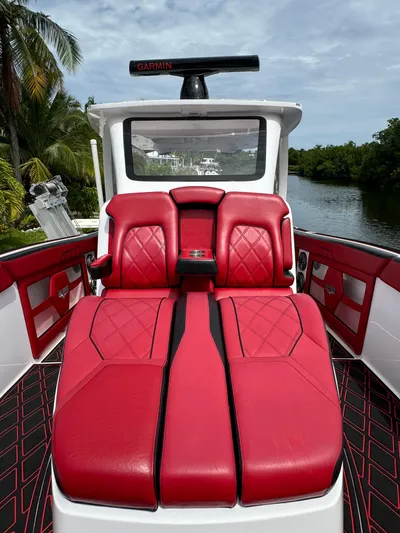  Yacht Photos Pics Luxurious 2022 Deep Impact 399 boat with red leather seating and sleek design.