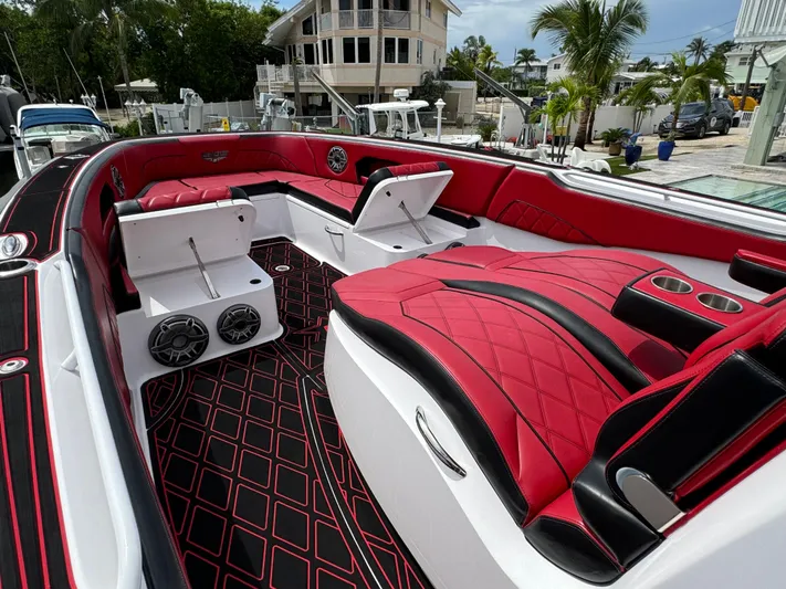  Yacht Photos Pics Luxurious 2022 Deep Impact 399 boat interior with red and black seating and modern design.