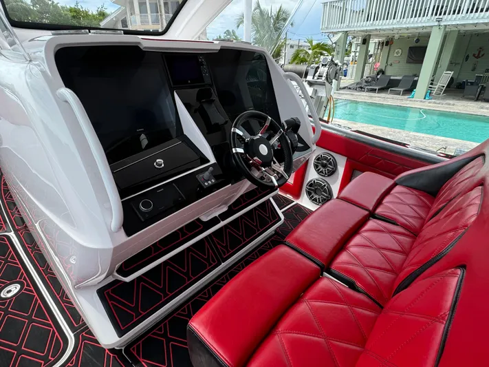  Yacht Photos Pics Luxury Deep Impact 399 boat interior with red seating and modern dashboard, 2022 model.
