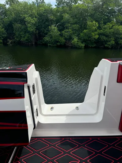  Yacht Photos Pics Deep Impact 399 boat, 2022 model, with open deck view by a lush riverbank.