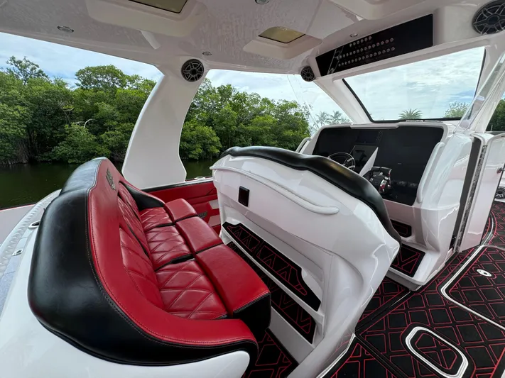  Yacht Photos Pics Luxurious 2022 Deep Impact 399 boat interior with red and black seating, sleek design.