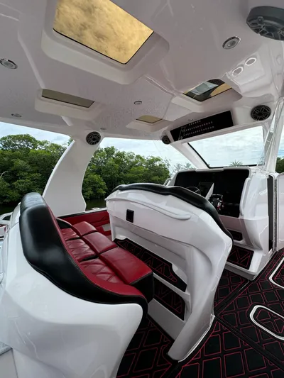  Yacht Photos Pics Luxurious interior of 2022 Deep Impact 399 boat with red and black seating.