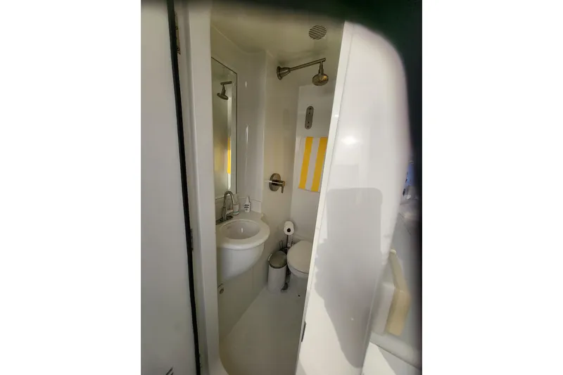 Lemonade Yacht Photos Pics Compact bathroom in 2007 Cheoy Lee 100 yacht, featuring shower, sink, and toilet.