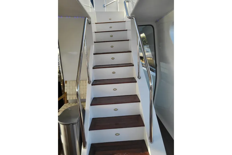 Lemonade Yacht Photos Pics Staircase on 2007 Cheoy Lee 100 yacht with wooden steps and metal railings.