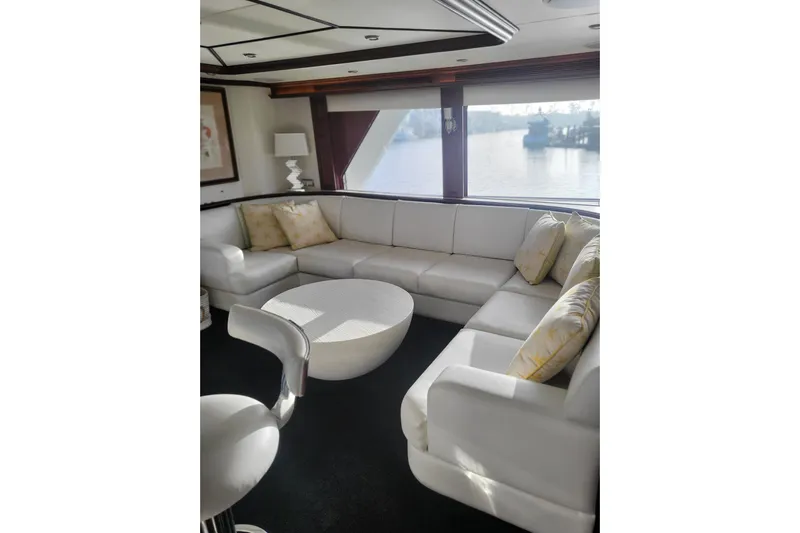 Lemonade Yacht Photos Pics Luxurious 2007 Cheoy Lee 100 yacht interior with elegant white seating and scenic window view.