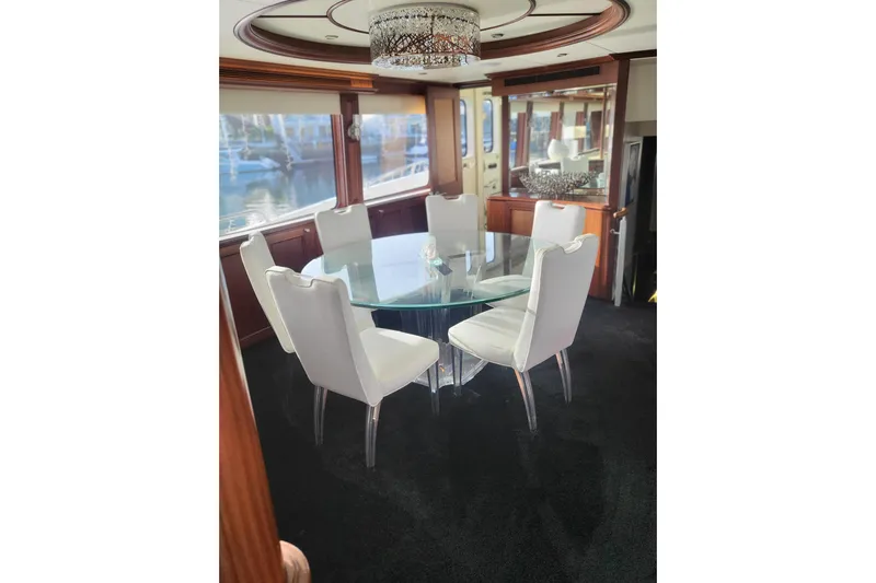 Lemonade Yacht Photos Pics Luxurious dining area on 2007 Cheoy Lee 100 yacht with glass table and white chairs.