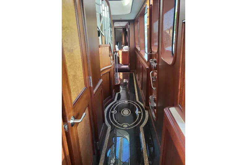 Lemonade Yacht Photos Pics Luxurious interior hallway of 2007 Cheoy Lee 100 yacht with elegant wood finishes.