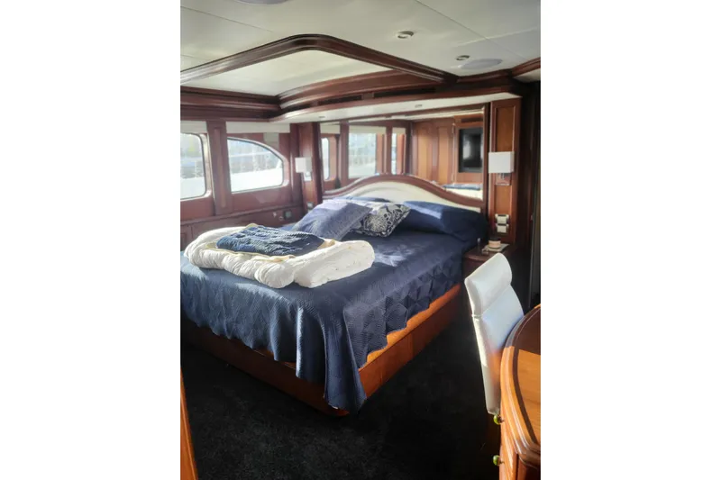 Lemonade Yacht Photos Pics Luxurious bedroom interior of 2007 Cheoy Lee 100 yacht with elegant wood finishes.