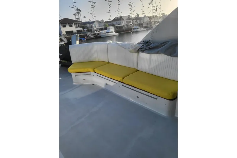 Lemonade Yacht Photos Pics Outdoor seating area on a 2007 Cheoy Lee 100 yacht with yellow cushions.