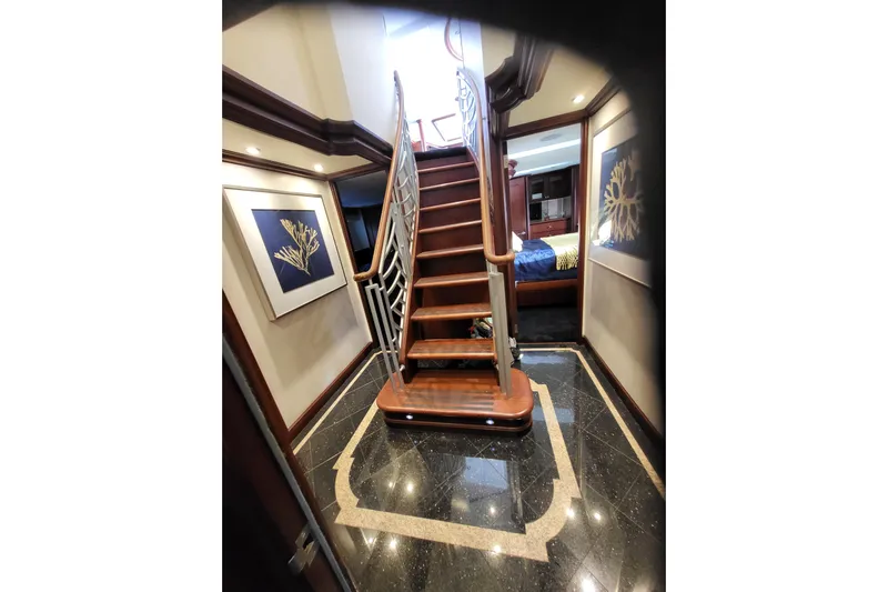 Lemonade Yacht Photos Pics Luxurious interior of 2007 Cheoy Lee 100 yacht with elegant staircase and artwork.