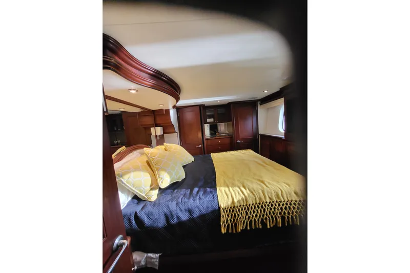 Lemonade Yacht Photos Pics Luxurious bedroom interior of 2007 Cheoy Lee 100 yacht with elegant wood finishes.