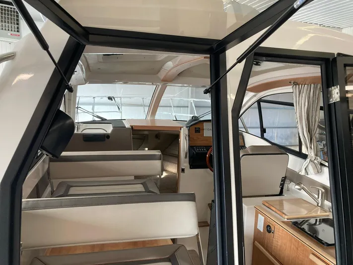  Yacht Photos Pics Interior of 2022 Cutwater C-24 Coupe boat, featuring seating and helm area.