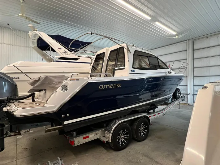  Yacht Photos Pics 2022 Cutwater C-24 Coupe boat on trailer in indoor storage facility.
