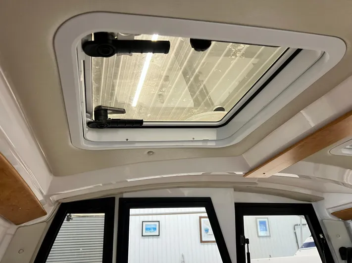  Yacht Photos Pics 2022 Cutwater C-24 Coupe interior with sunroof and modern design elements.