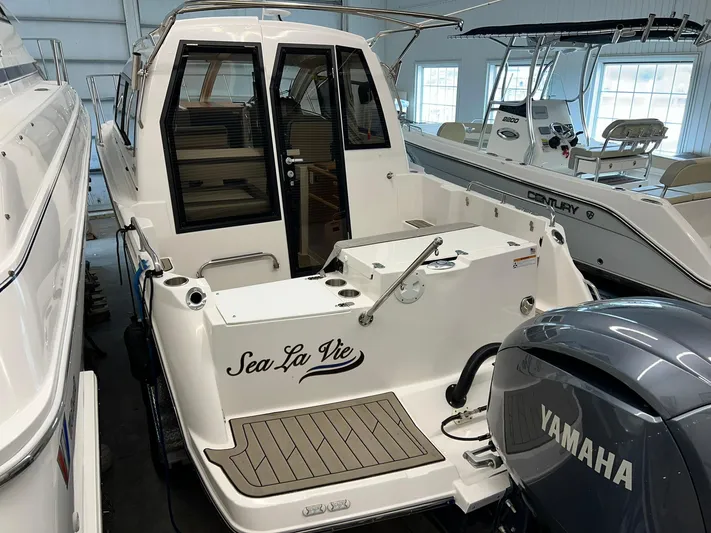  Yacht Photos Pics 2022 Cutwater C-24 Coupe boat with Yamaha engine, docked indoors.