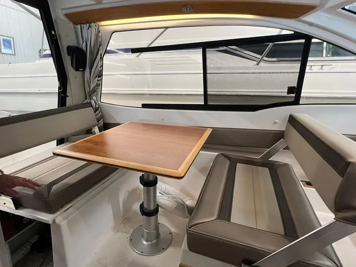  Yacht Photos Pics Interior of 2022 Cutwater C-24 Coupe with dining area and wooden table.