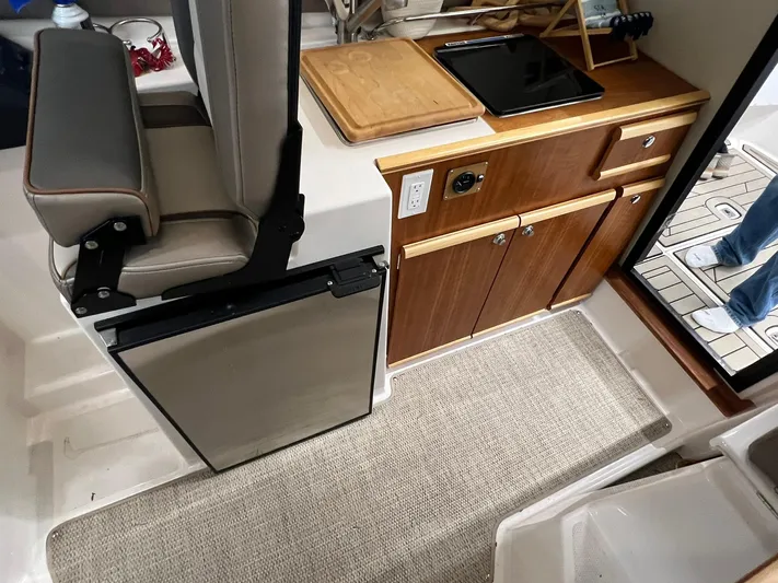  Yacht Photos Pics 2022 Cutwater C-24 Coupe interior with kitchenette, seating, and modern amenities.