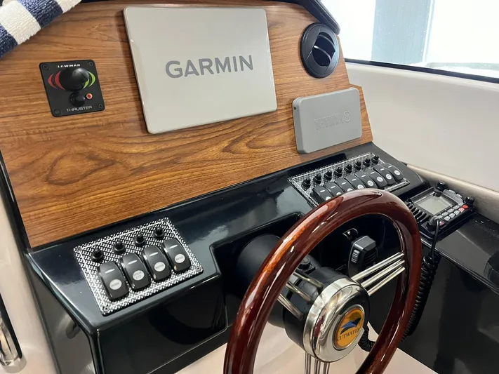  Yacht Photos Pics 2022 Cutwater C-24 Coupe dashboard with Garmin navigation and wood accents.