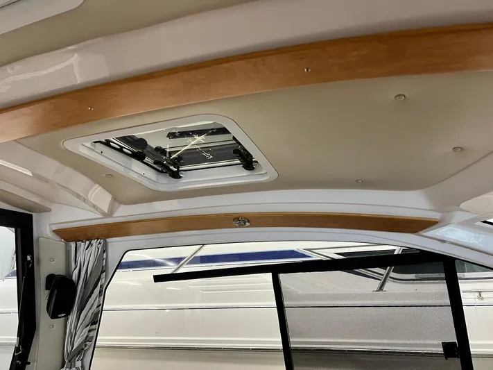 Yacht Photos Pics 2022 Cutwater C-24 Coupe interior ceiling with wood accents and a skylight.