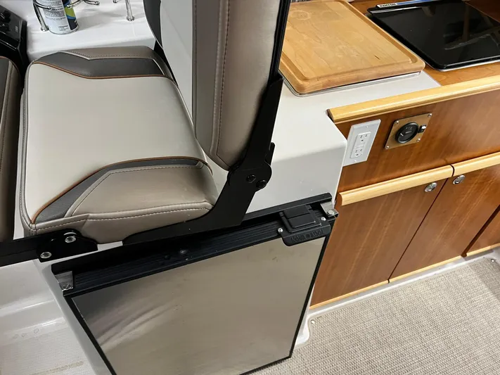  Yacht Photos Pics Interior of 2022 Cutwater C-24 Coupe featuring seating and kitchenette area.