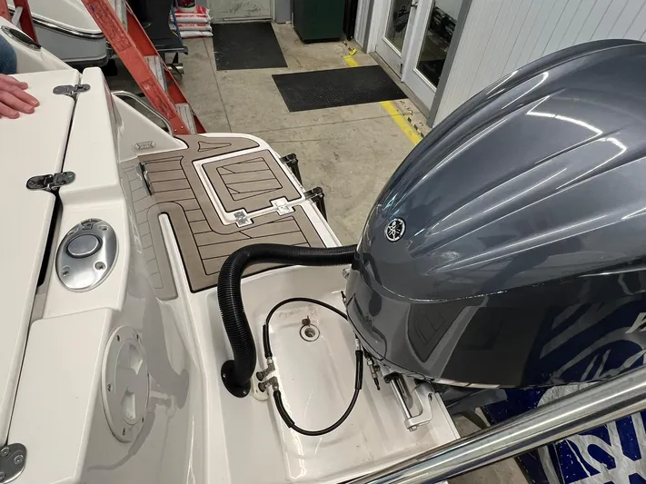  Yacht Photos Pics 2022 Cutwater C-24 Coupe boat with outboard motor in a showroom setting.