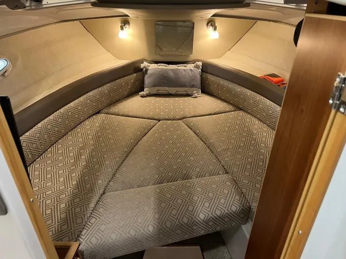  Yacht Photos Pics 2022 Cutwater C-24 Coupe cabin interior with patterned cushions and ambient lighting.