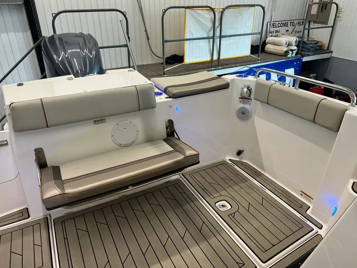  Yacht Photos Pics 2022 Cutwater C-24 Coupe boat interior with cushioned seating and teak-style flooring.